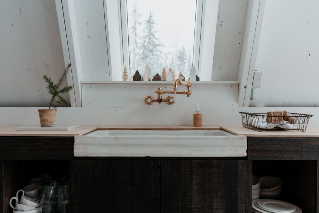 Raw brass faucet from Waterworks in an A-frame cabin kitchen
