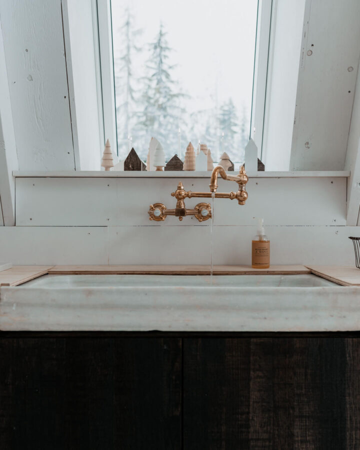 Raw brass faucet from Waterworks in an A-frame cabin kitchen